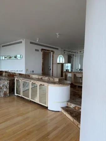 a kitchen with stainless steel appliances a sink and cabinets