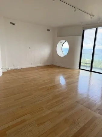 a view of a room with wooden floor and window