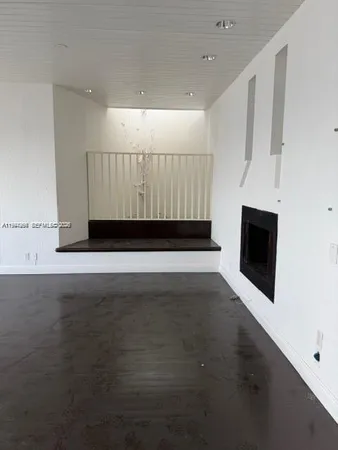 wooden floor in an empty room with a fireplace