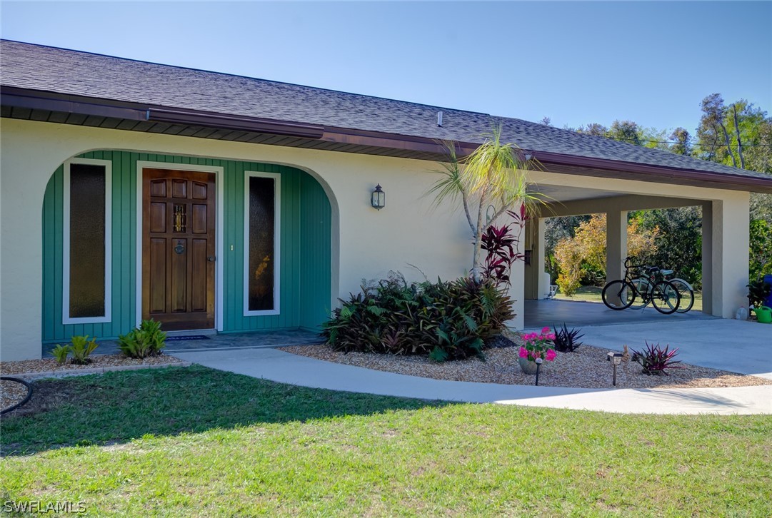 13970 Elkins Road Fort Myers, FL 33913 - Photo 3 of 35 a front view of a house with a porch