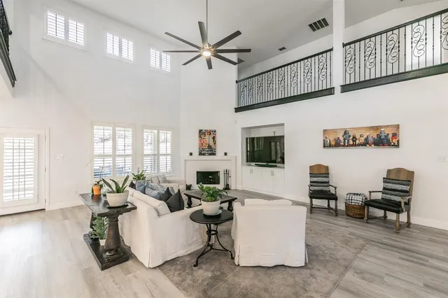 a living room with furniture a flat screen tv and a window