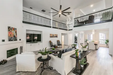 a living room with fireplace furniture and a flat screen tv