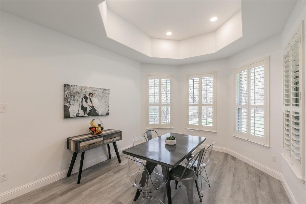 12548 Avondale Ridge Drive Fort Worth, TX 76179 - Photo 18 of 40 Dining space with a tray ceiling, light wood finished floors, baseboards, and a wealth of natural light