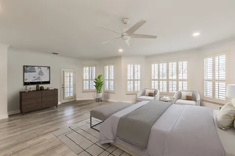 a bedroom with a large bed and a large window