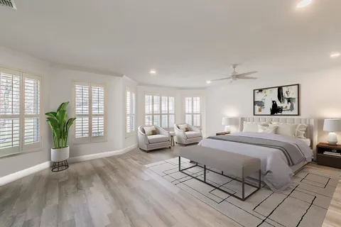 a spacious bedroom with a bed and a couch