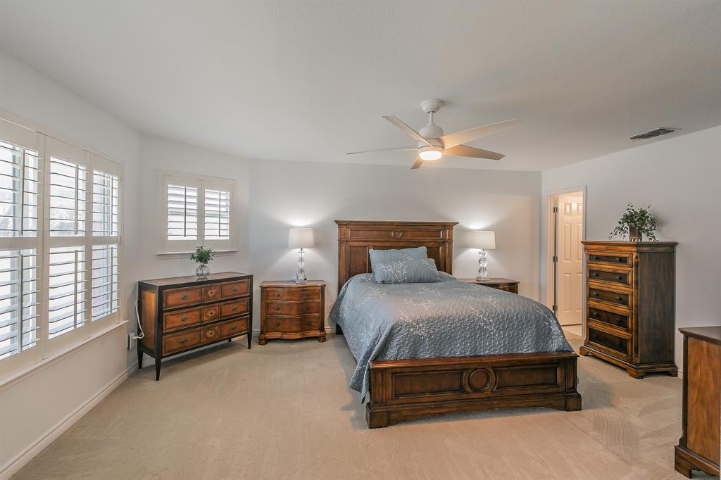 12548 Avondale Ridge Drive Fort Worth, TX 76179 - Photo 35 of 40 Bedroom featuring visible vents, baseboards, carpet, and ceiling fan w/ ensuite bathroom attached. Could be a second primary.