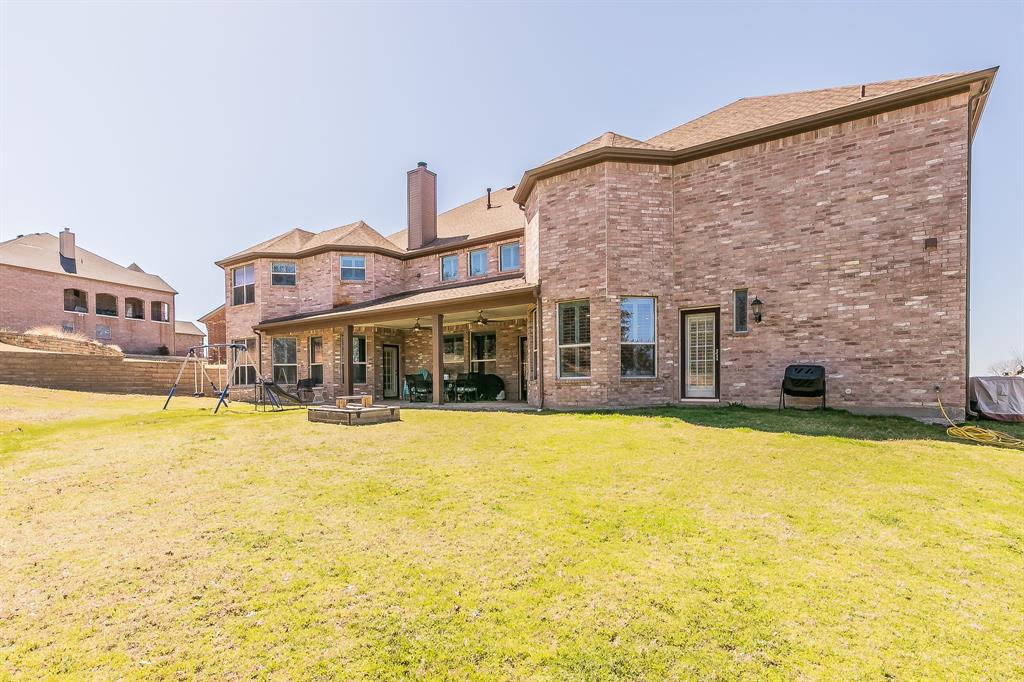 12548 Avondale Ridge Drive Fort Worth, TX 76179 - Photo 38 of 40 Back of property with a yard and brick siding