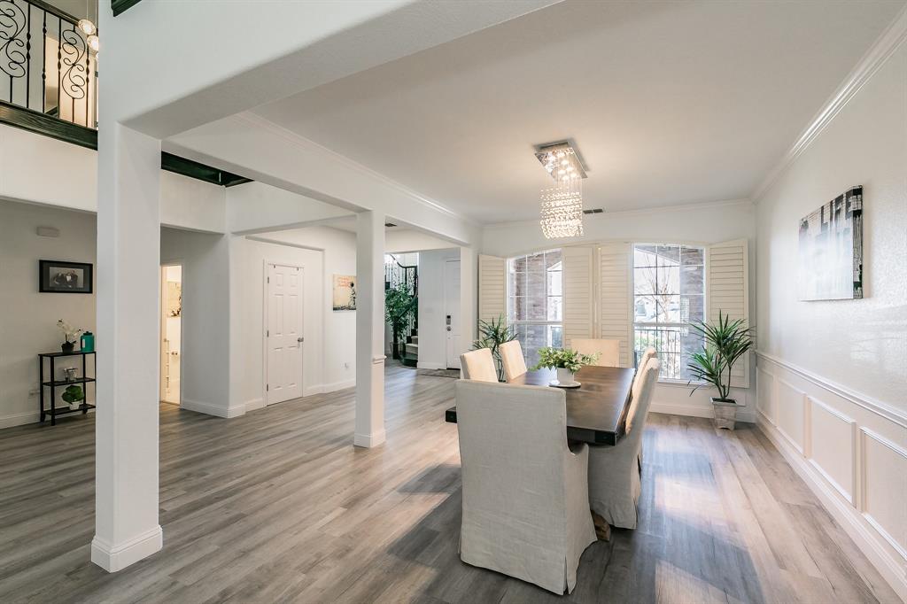12548 Avondale Ridge Drive Fort Worth, TX 76179 - Photo 7 of 40 Dining space with wainscoting, wood finished floors, crown molding, and a decorative wall