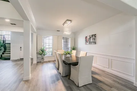 a dining room with furniture wooden floor and a rug