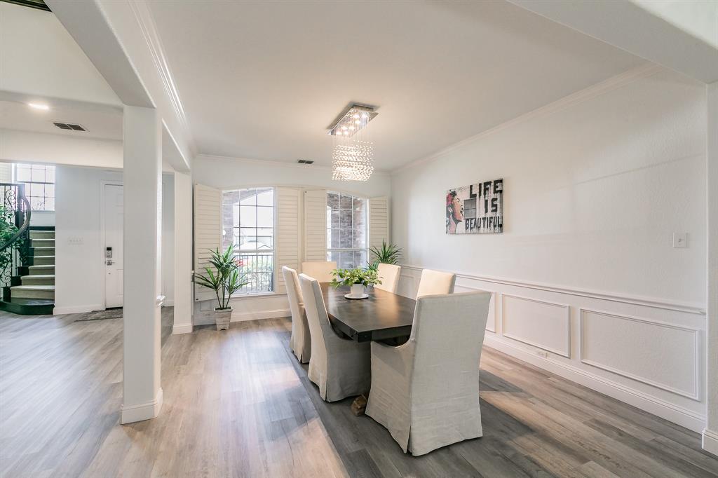 12548 Avondale Ridge Drive Fort Worth, TX 76179 - Photo 8 of 40 Dining area featuring crown molding, a chandelier, stairway, a wainscoted wall, and wood finished floors