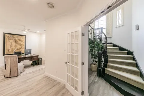 a view of entryway and hall with wooden floor