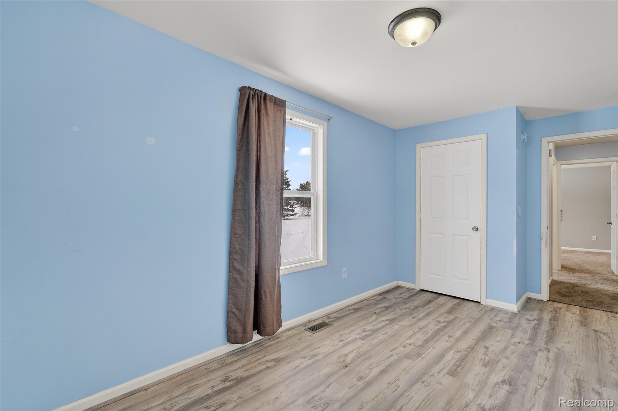5417 Rensselear Drive Lapeer, MI 48446 - Photo 29 of 41 Unfurnished bedroom with light wood-style floors and baseboards