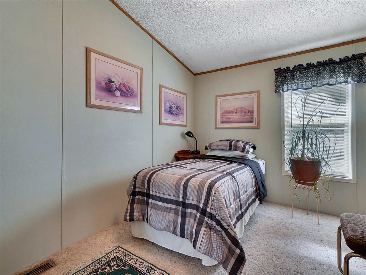 435 32 Road, Unit 705 Clifton, CO 81520 - Photo 11 of 16 a bed room with a bed and a chair