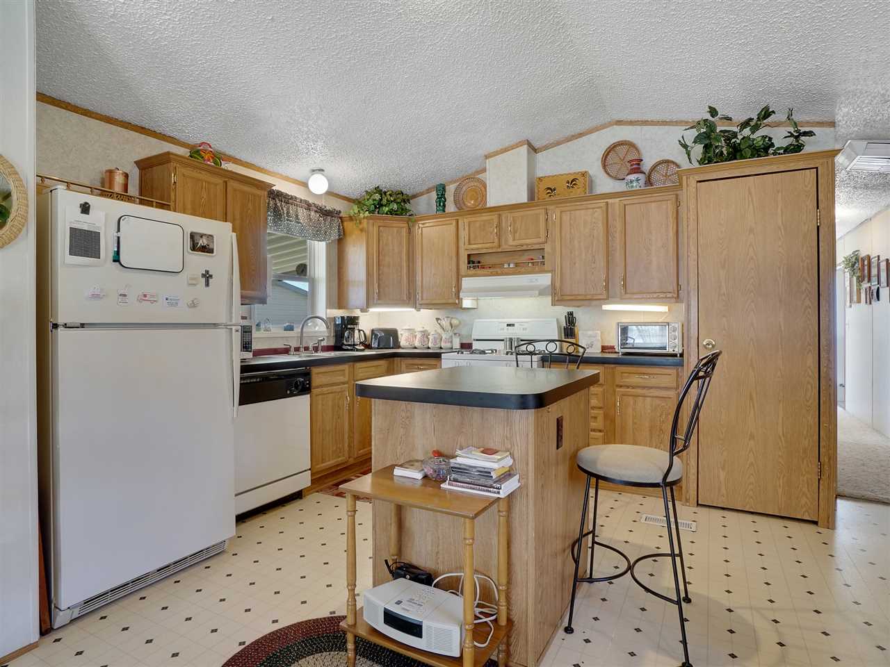 435 32 Road, Unit 705 Clifton, CO 81520 - Photo 5 of 16 a kitchen with refrigerator and cabinets