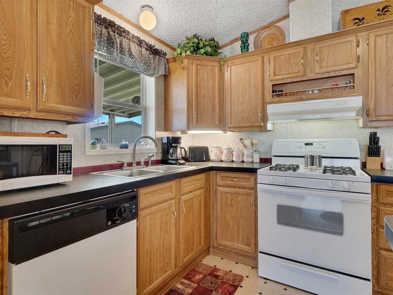435 32 Road, Unit 705 Clifton, CO 81520 - Photo 6 of 16 a kitchen with stainless steel appliances a stove a sink and a microwave