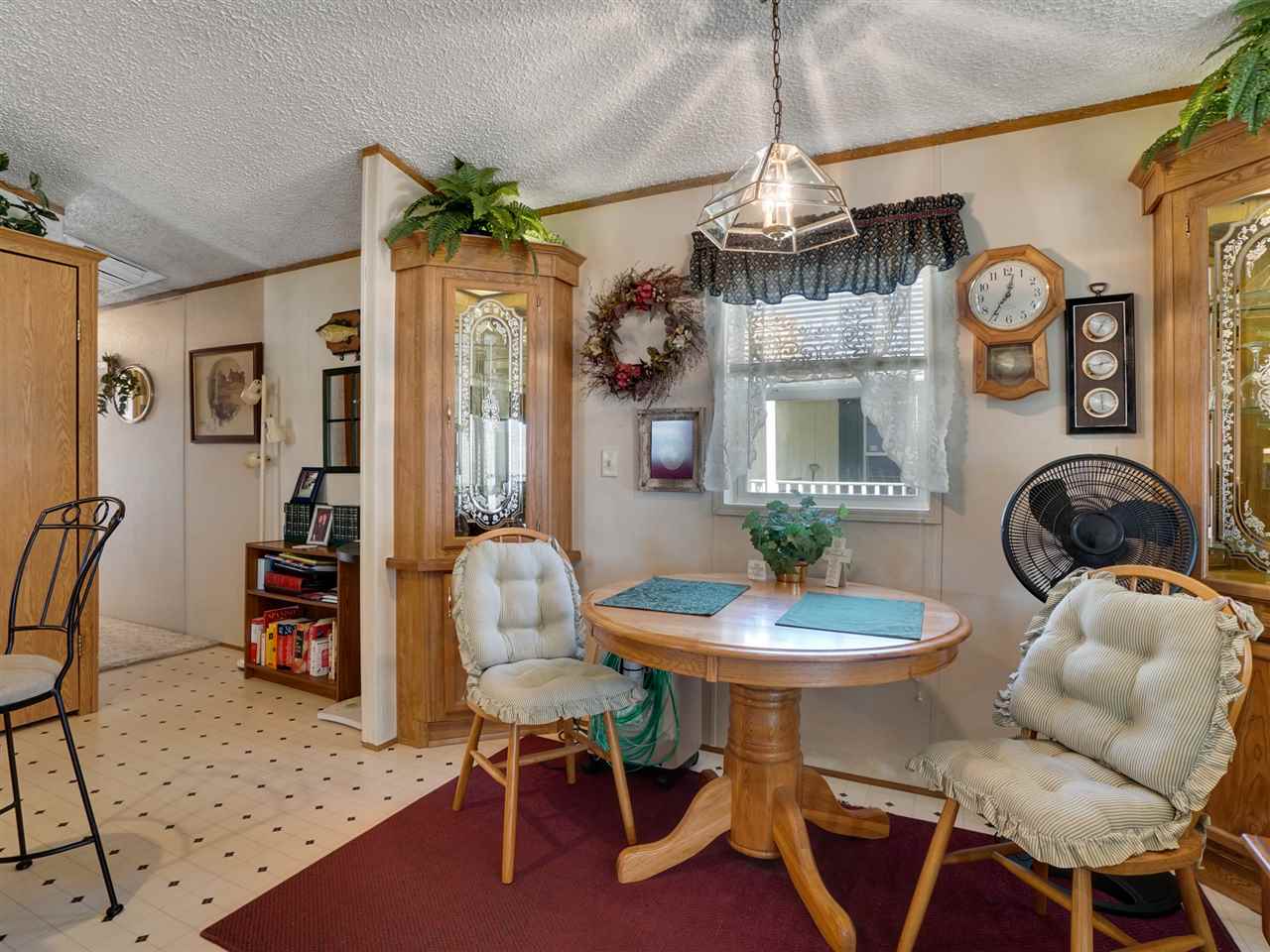 435 32 Road, Unit 705 Clifton, CO 81520 - Photo 7 of 16 a dining room with furniture a chandelier and wooden floor
