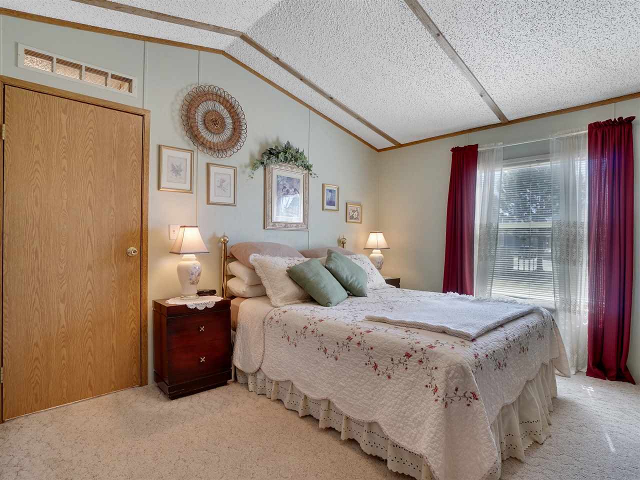 435 32 Road, Unit 705 Clifton, CO 81520 - Photo 8 of 16 a spacious bedroom with a bed and a window