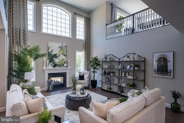 a living room with furniture a fireplace and a window