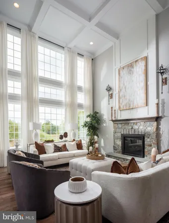 a living room with fireplace furniture and a large window