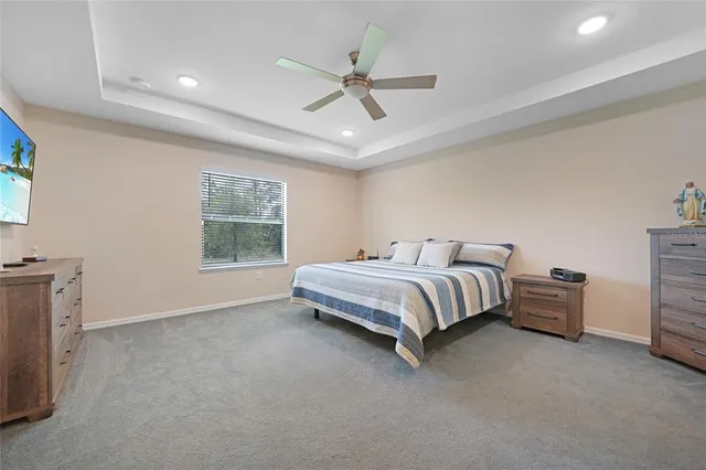 a spacious bedroom with a bed and a chandelier