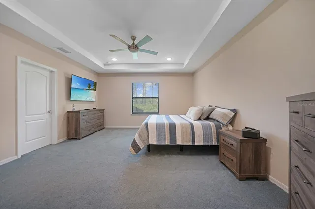 a spacious bathroom with a granite countertop sink mirror and bathtub