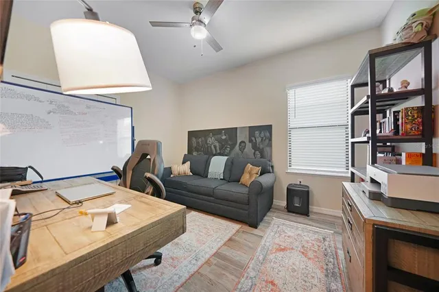 a view of a livingroom with workspace and a couch