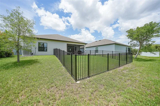 a view of a house with backyard and entertaining space