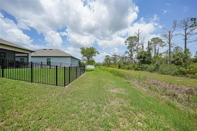 an aerial view of multiple houses with a yard