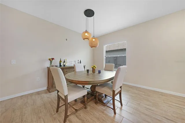 a view of a dining room that has a table and chairs in it