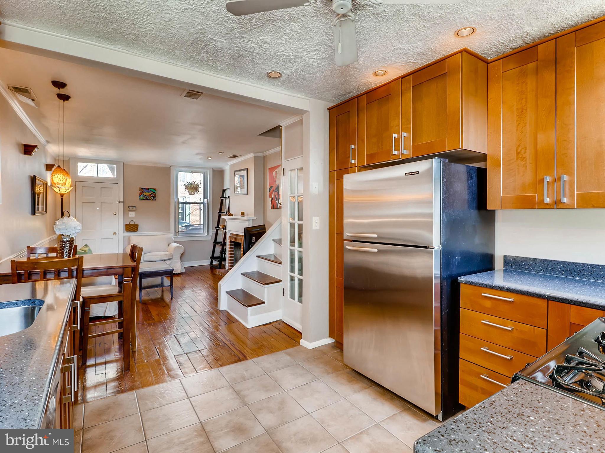 1212 Riverside Avenue Baltimore, MD 21230 - Photo 11 of 27 a kitchen with stainless steel appliances granite countertop a refrigerator a stove and a microwave oven with cabinets