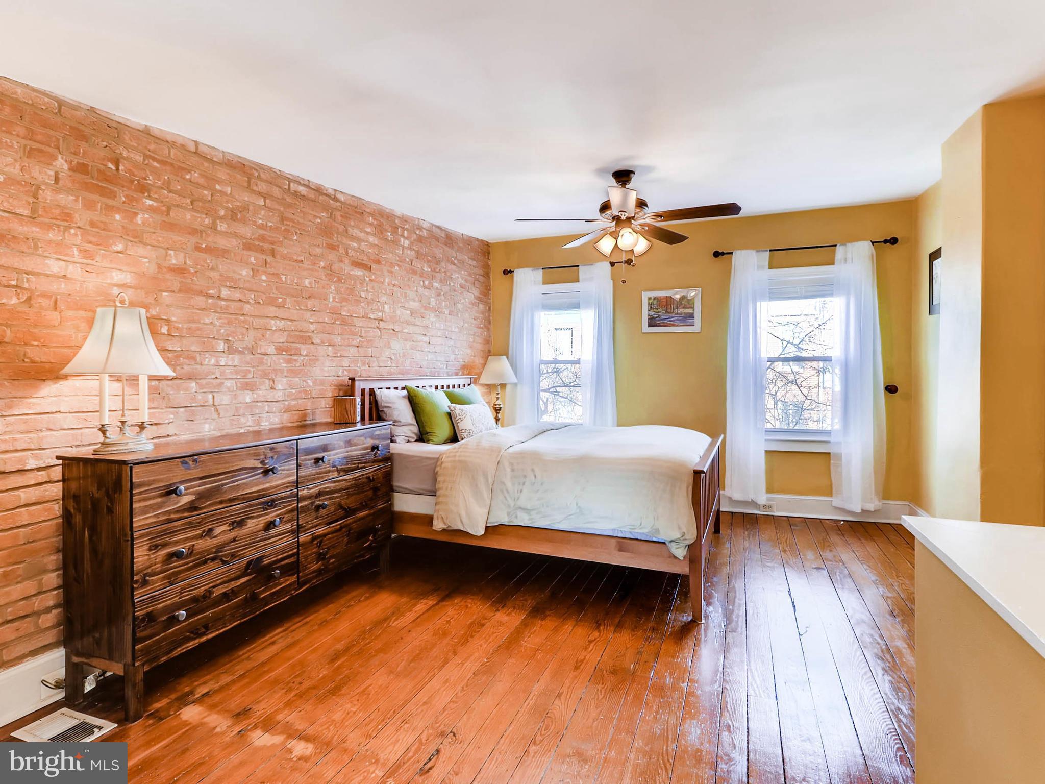 1212 Riverside Avenue Baltimore, MD 21230 - Photo 13 of 27 a bedroom with a bed and a chandelier