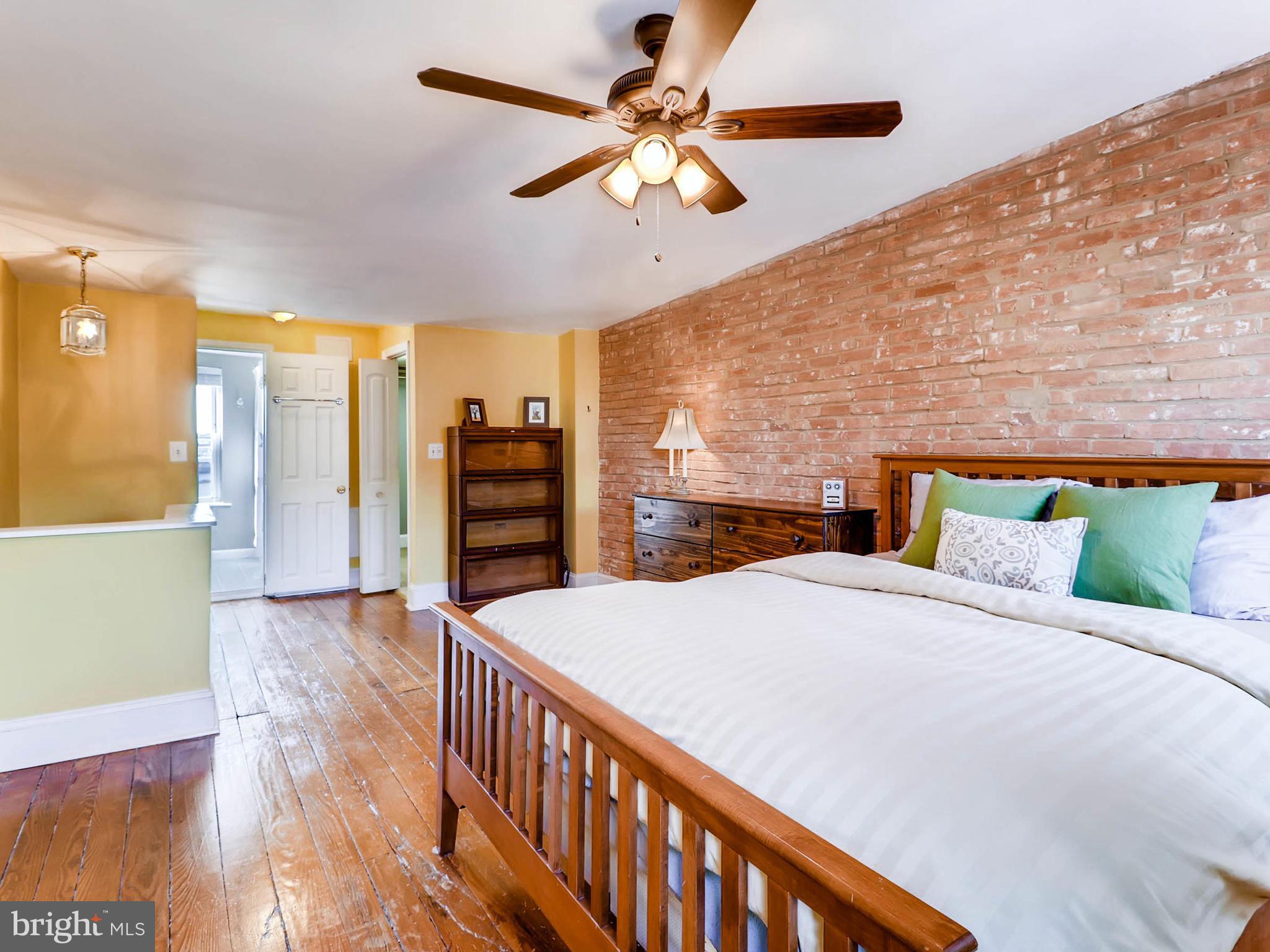 1212 Riverside Avenue Baltimore, MD 21230 - Photo 14 of 27 a bedroom with a bed and a ceiling fan