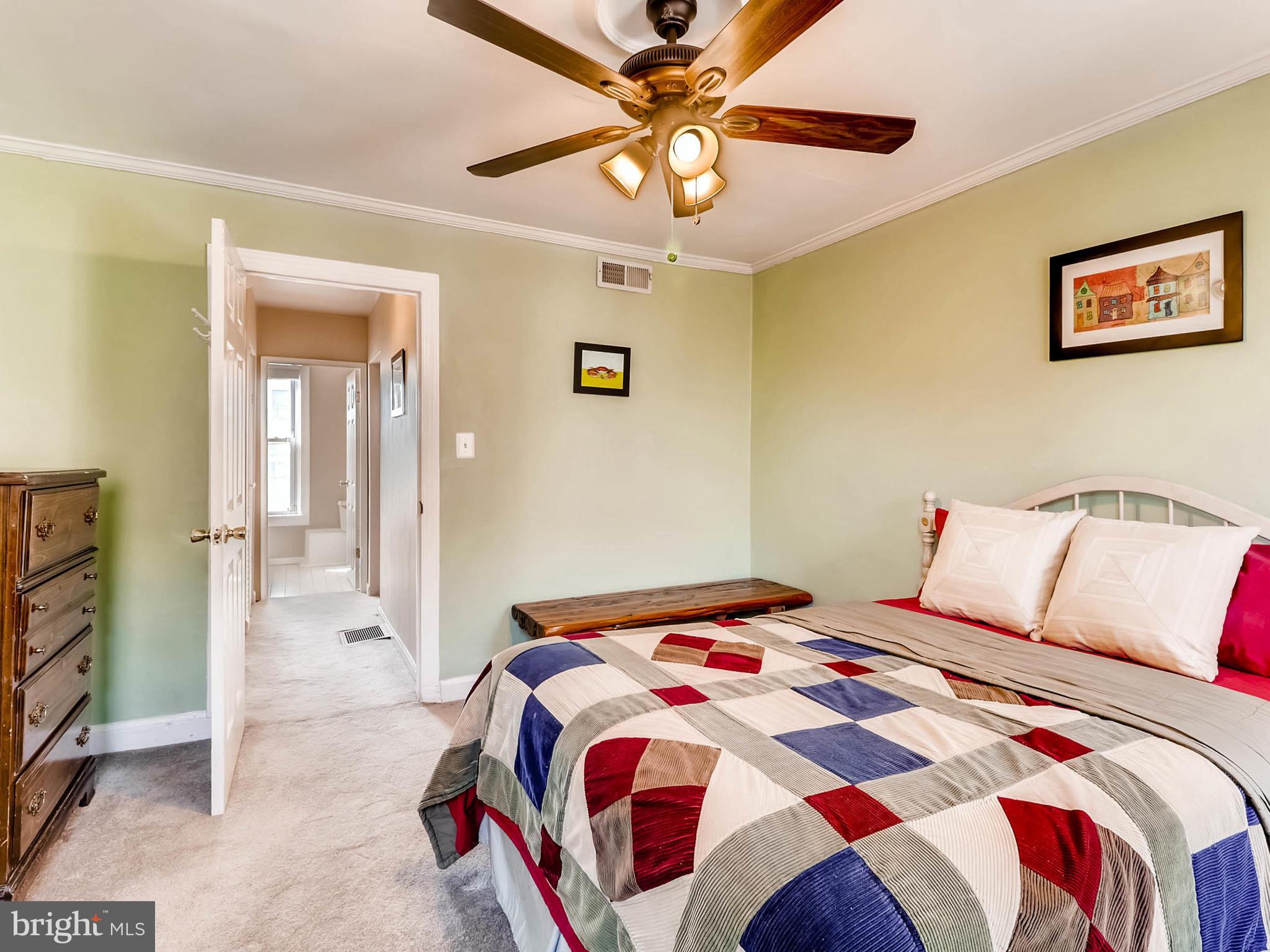 1212 Riverside Avenue Baltimore, MD 21230 - Photo 18 of 27 a bedroom with a bed and a chandelier