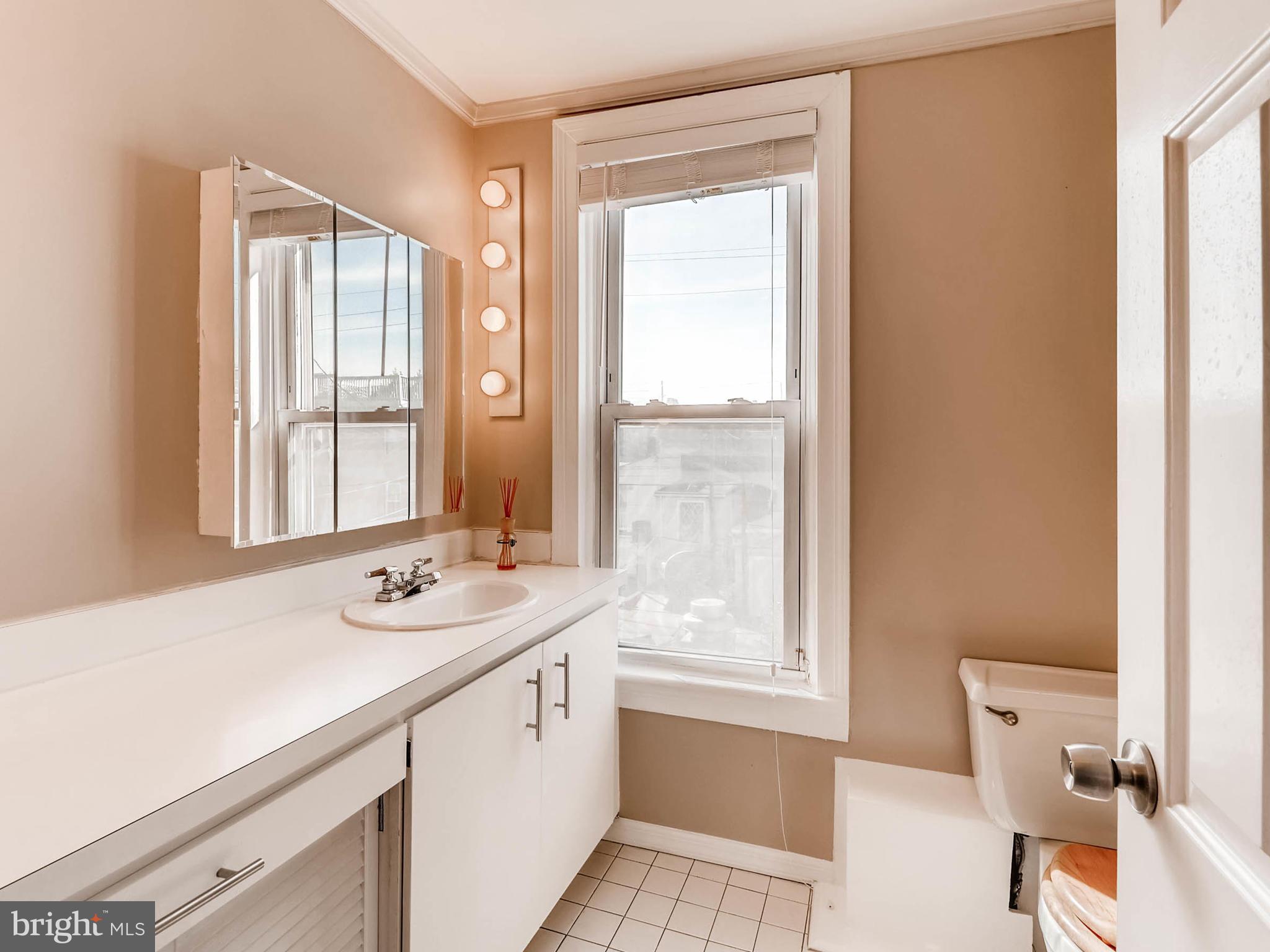 1212 Riverside Avenue Baltimore, MD 21230 - Photo 19 of 27 a bathroom with a sink and a window