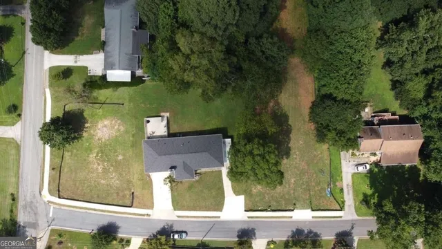 an aerial view of a house with a yard
