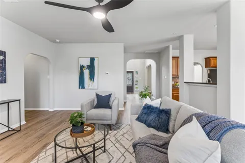 a living room with furniture and a chandelier