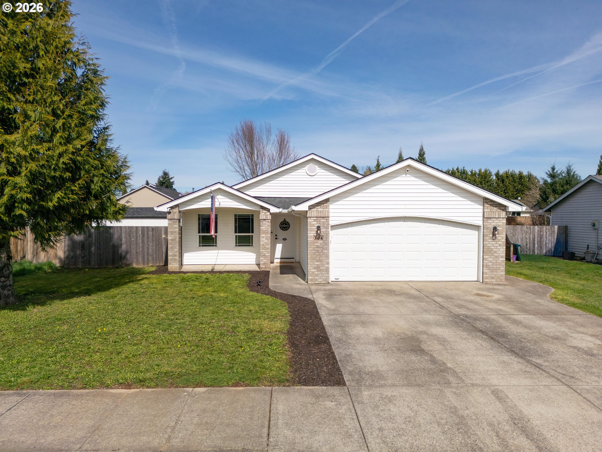 304 East Wilson Street Yacolt, WA 98675 - Photo 1 of 29 a front view of a house with a yard and garage