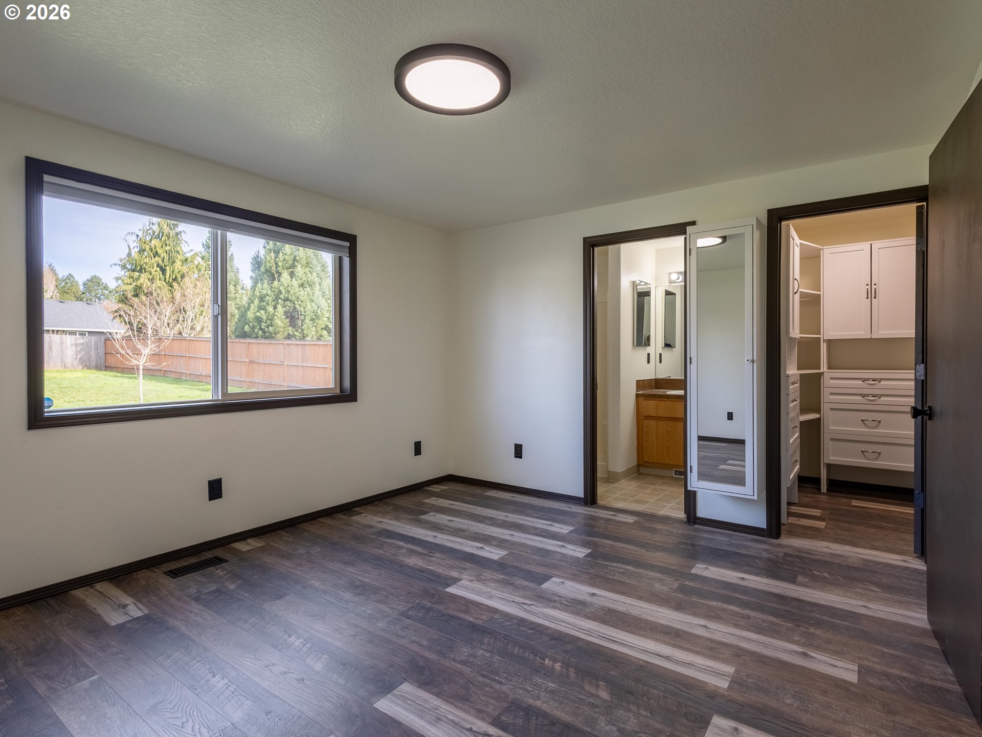 304 East Wilson Street Yacolt, WA 98675 - Photo 11 of 29 a view of an empty room with wooden floor and a window