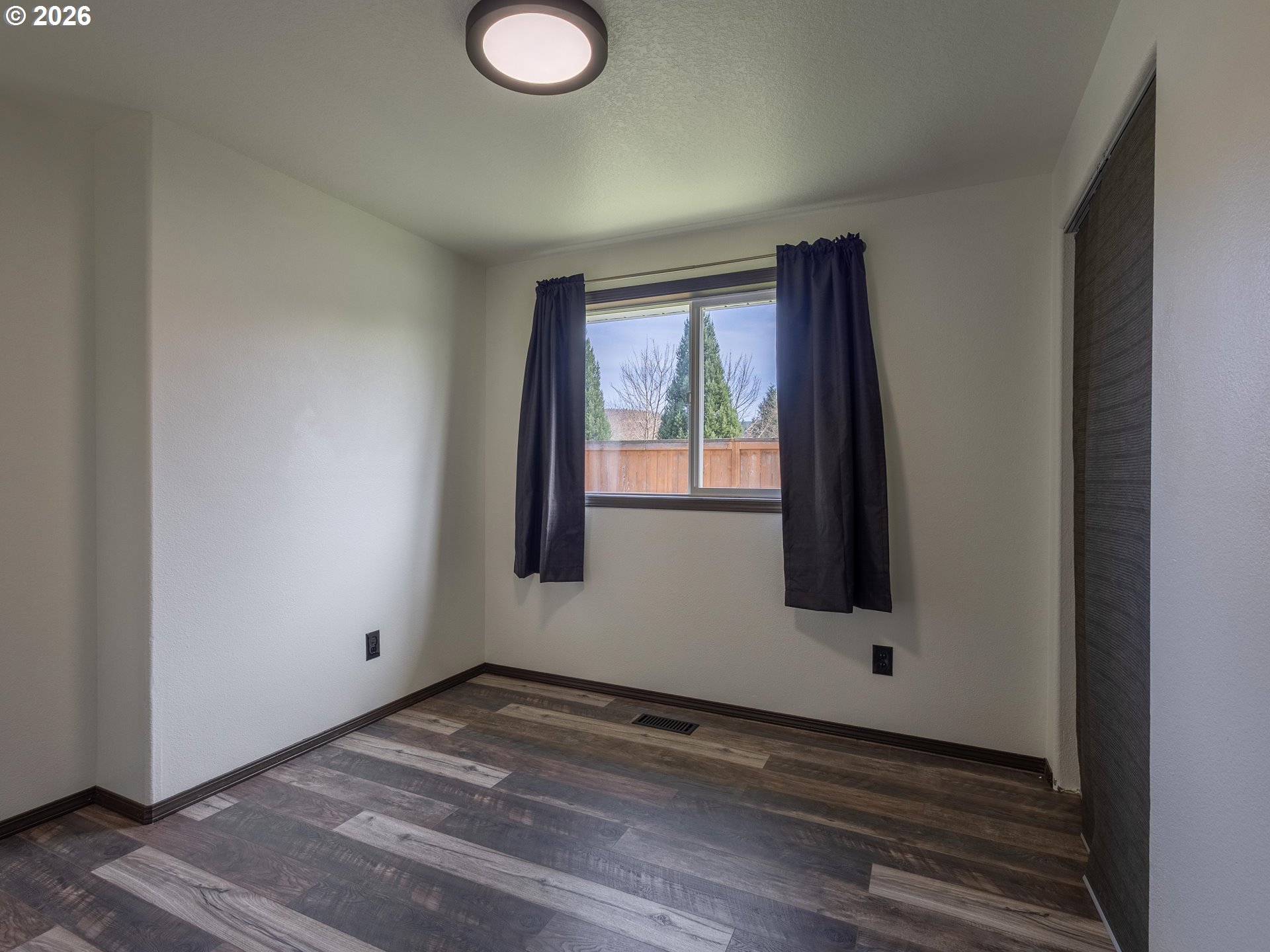 304 East Wilson Street Yacolt, WA 98675 - Photo 14 of 29 a view of a livingroom with wooden floor and window