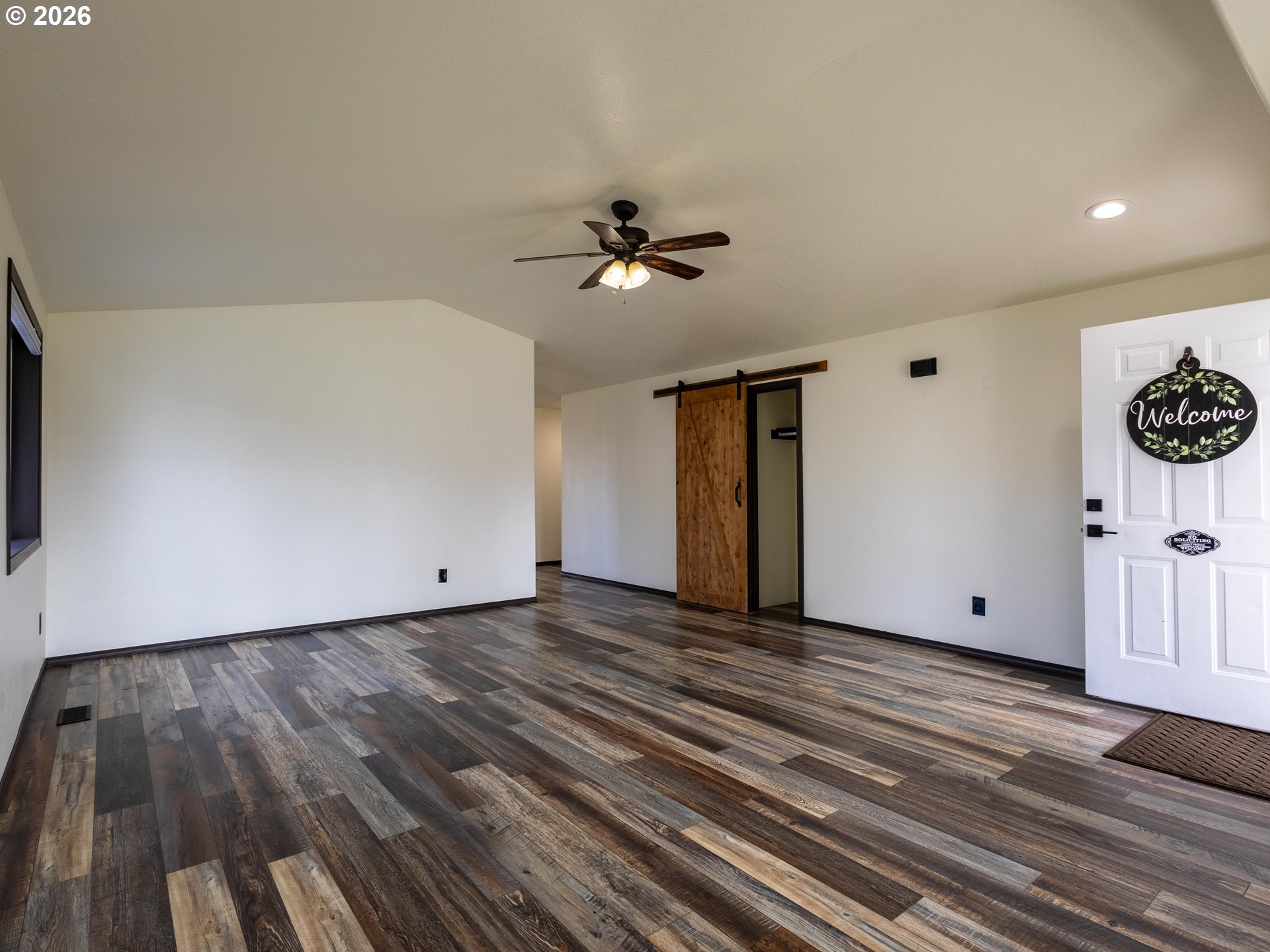 304 East Wilson Street Yacolt, WA 98675 - Photo 5 of 29 a view of a livingroom with wooden floor and a ceiling fan