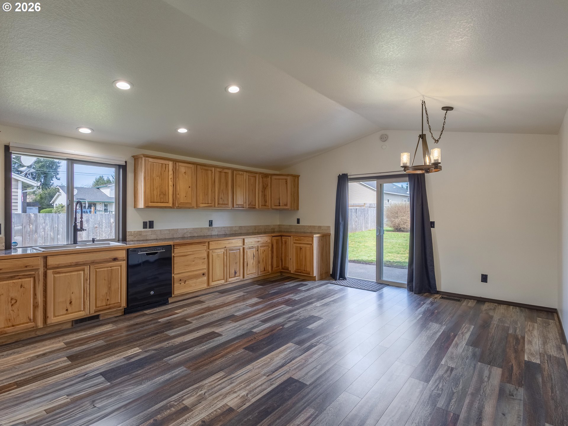 304 East Wilson Street Yacolt, WA 98675 - Photo 9 of 29 a large kitchen with granite countertop a stove top oven a sink and dishwasher with wooden floor