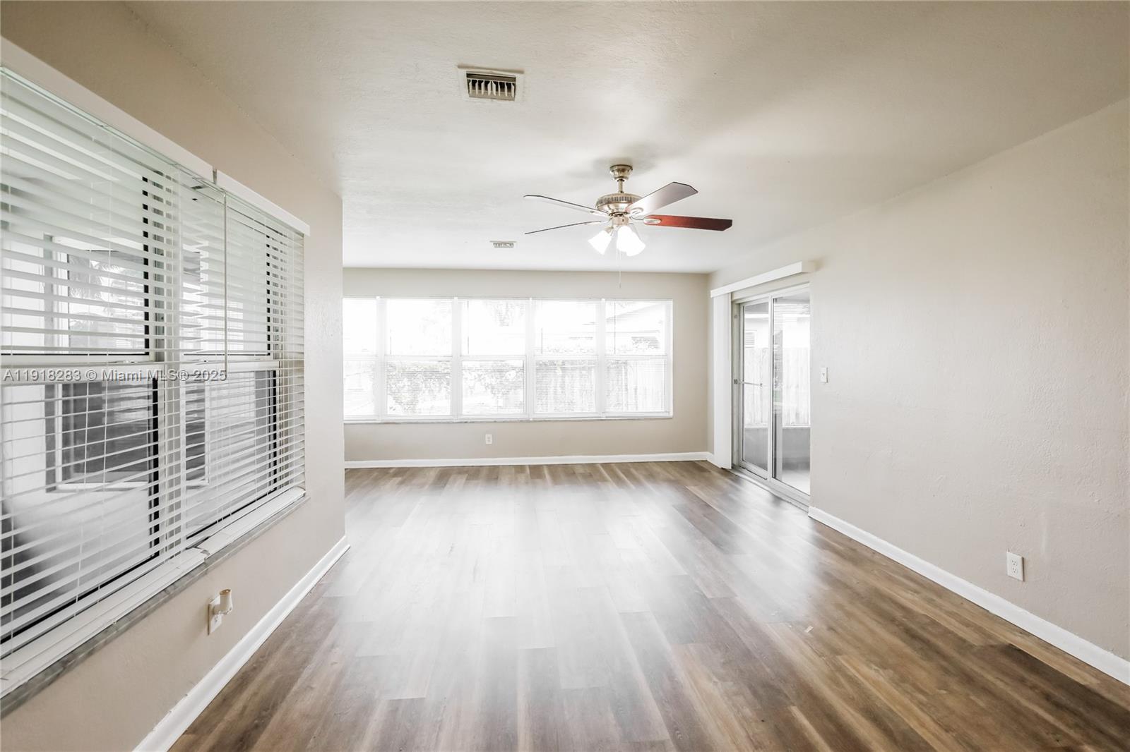 6212 Northwest 15th Court Margate, FL 33063 - Photo 4 of 16 a view of an empty room with a window and wooden floor