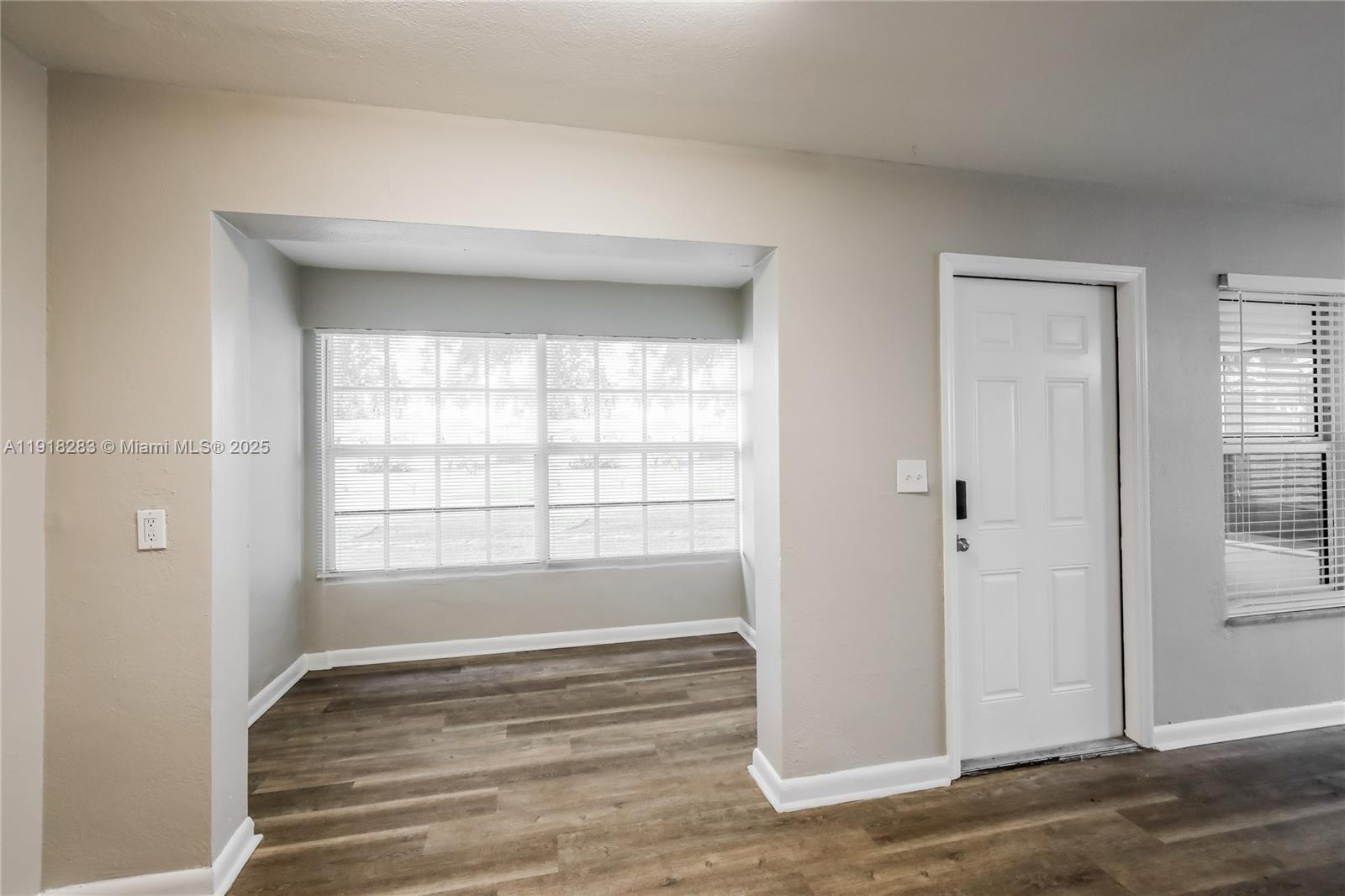 6212 Northwest 15th Court Margate, FL 33063 - Photo 5 of 16 a view of an empty room with wooden floor and a window