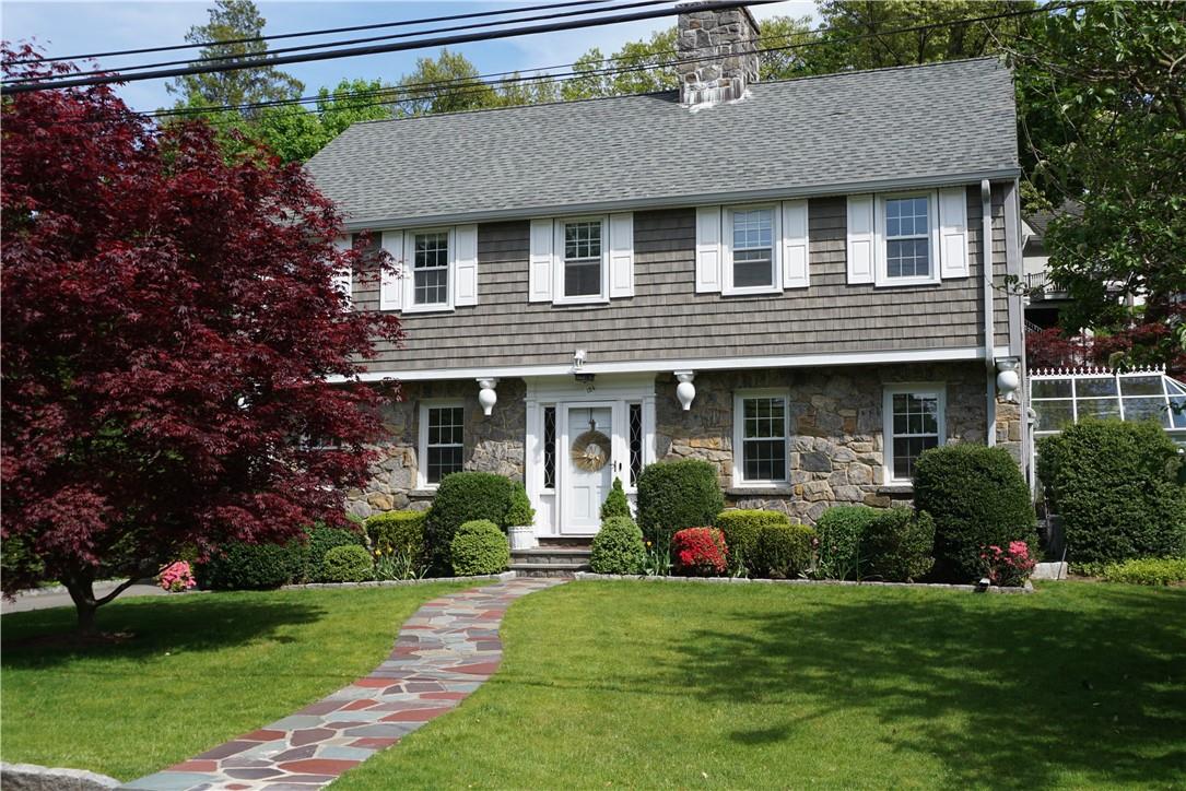 124 Longvale Road Bronxville, NY 10708 - Photo 1 of 1 a front view of a house with a yard and potted plants