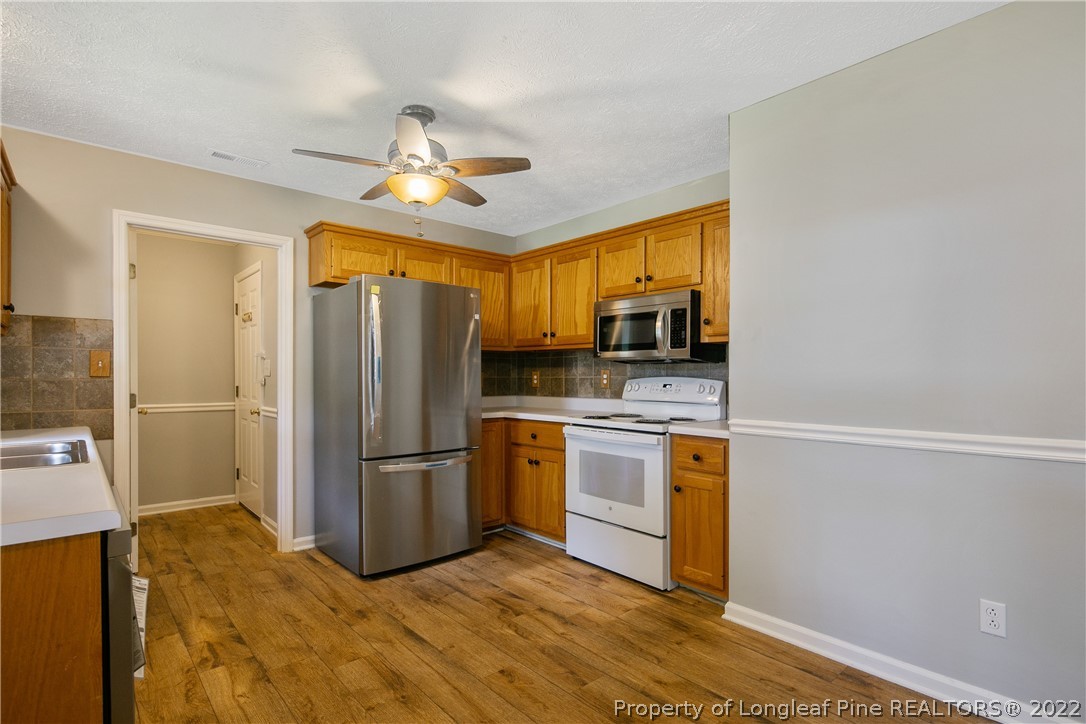 203 Cobblestone Court Raeford, NC 28376 - Photo 11 of 46 a kitchen with stainless steel appliances granite countertop a refrigerator a stove top oven a sink and dishwasher