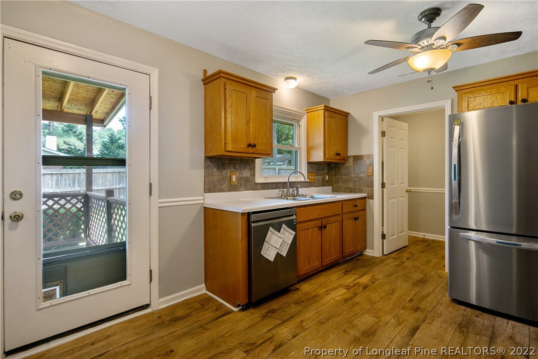 203 Cobblestone Court Raeford, NC 28376 - Photo 13 of 46 a kitchen with stainless steel appliances granite countertop a refrigerator a stove a sink and a microwave
