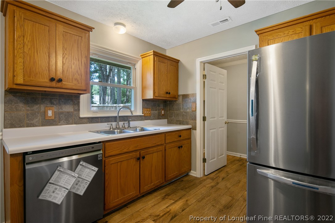 203 Cobblestone Court Raeford, NC 28376 - Photo 16 of 46 a kitchen with stainless steel appliances granite countertop a refrigerator and a sink