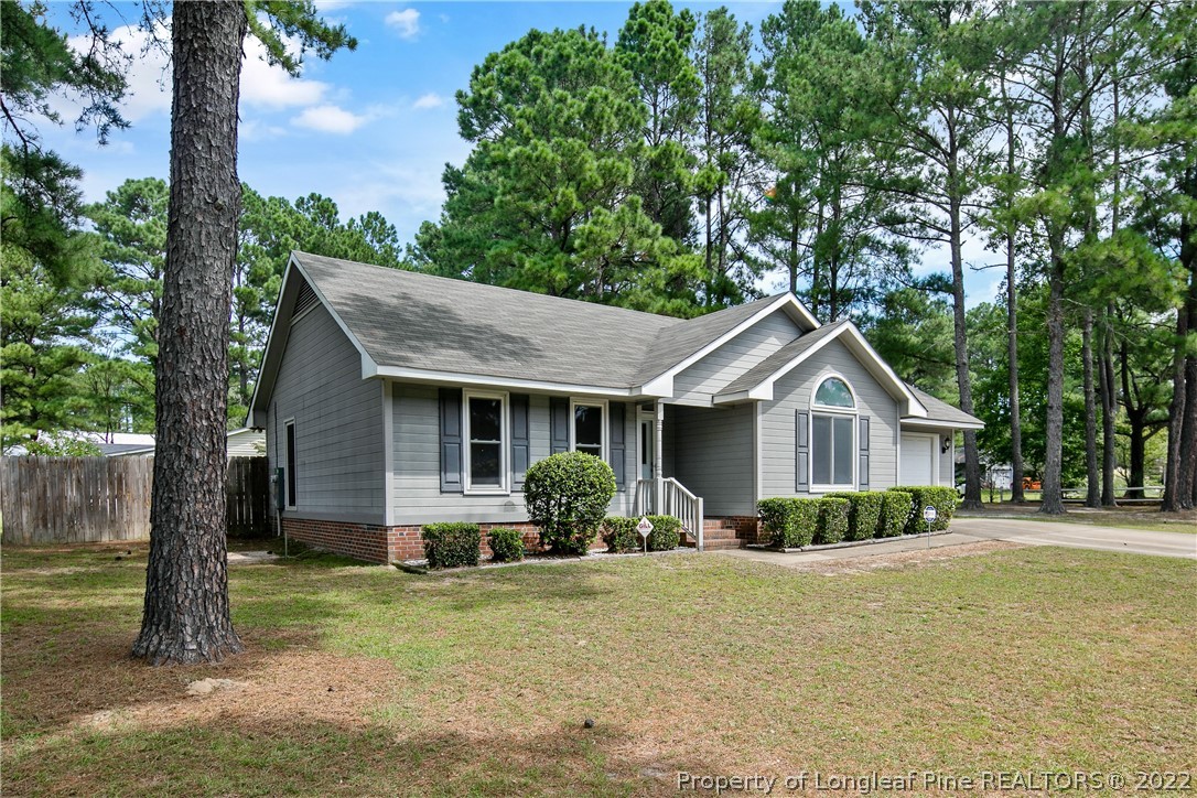203 Cobblestone Court Raeford, NC 28376 - Photo 2 of 46 a front view of a house with garden