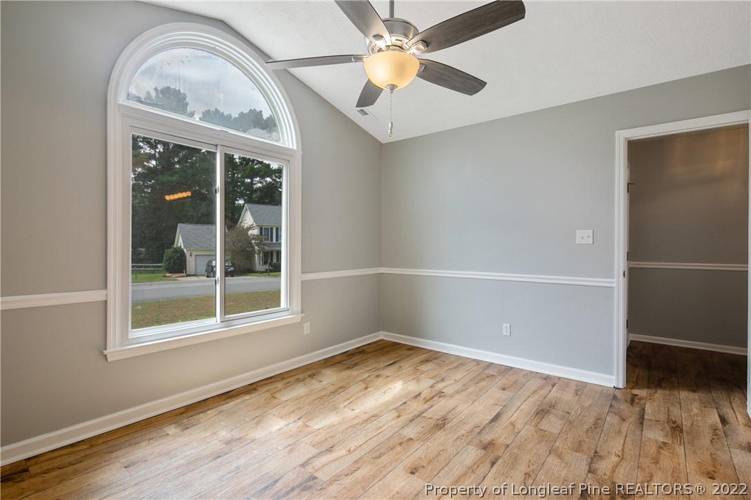 203 Cobblestone Court Raeford, NC 28376 - Photo 22 of 46 an empty room with wooden floor fan and windows