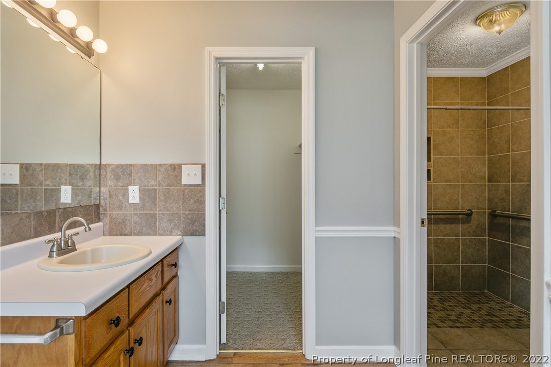 203 Cobblestone Court Raeford, NC 28376 - Photo 25 of 46 a bathroom with a sink shower and a mirror